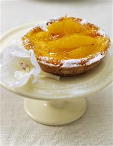 One orange and walnut tart on cake stand