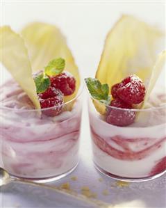 Two glasses of raspberry buttermilk cream with almond wafers