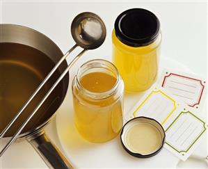 Ladling fish stock into jars