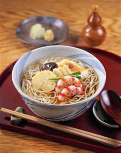 Japanese noodle soup with shrimps, omelette, vegetables