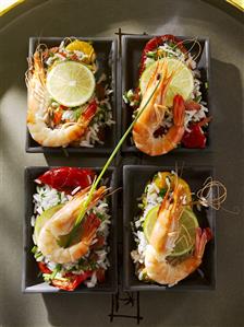 Four bowls of rice salad with red peppers and prawns