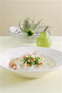 Vegetable soup with strips of cured pork, pear & mustard