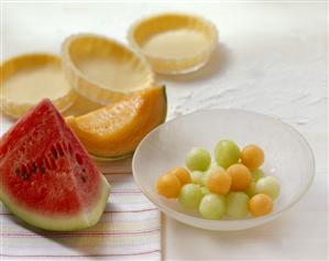 Baking still life with melon and uncooked tart shells