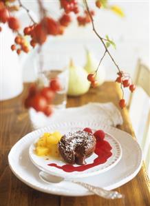 Chocolate pudding with chilli pears and raspberry sauce