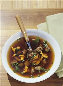 Venison soup with bacon and chanterelles