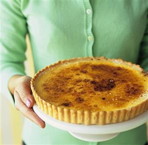 Woman holding a lemon tart