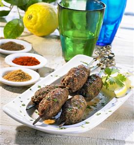 Three Moroccan spiced kofta kebabs with lemon