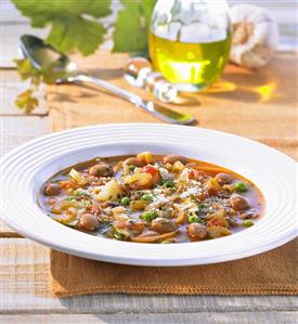 A serving of minestrone in a soup plate