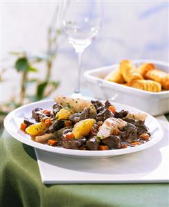 Venison goulash with pears, oranges and potato croquettes