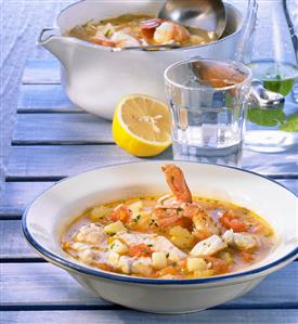 Greek fish soup in bowl and dish