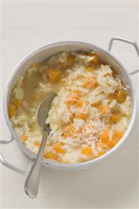 Pumpkin risotto in aluminium pan with spoon