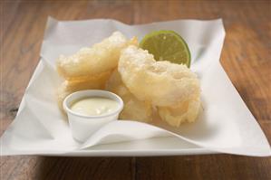 Tempura appetisers with lime mayonnaise on a square plate