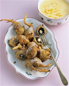 Schlosserbuben (prune fritters) with orange sauce