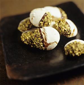 Chocolate-dipped meringues with pistachios