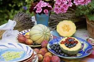 Cantaloupe melons, fresh berries and plums out of doors