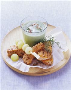 Cold cucumber soup with coriander salmon and melon balls