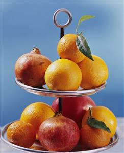 Citrus fruit and pomegranates on tiered stand