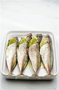 Marinated sardines with lime wedges