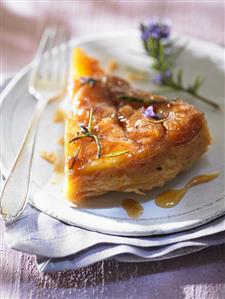 A piece of Tarte Tatin with rosemary