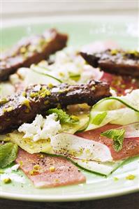 Pork ribs on melon and cucumber carpaccio