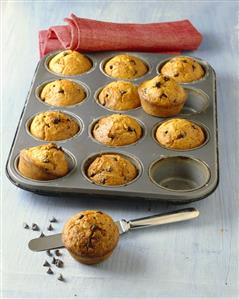 Carrot & almond muffins with chocolate chips in muffin tin