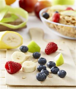 Breakfast ingredients: fruit, berries and cornflakes