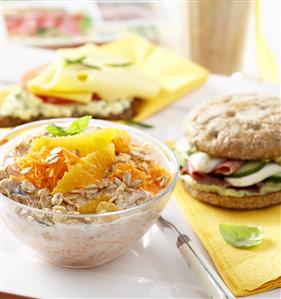 Muesli with oranges, filled roll, scrambled egg on bread