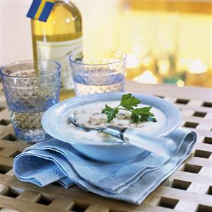 Mushroom soup and bottle of white wine with Swedish flag