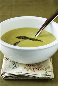 Asparagus cream soup in white bowl