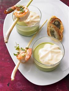 Ramsons (wild garlic) foam soup with prawns on lemon grass skewers