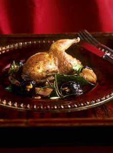 Quail with walnut-stuffed prunes and spicy grape sauce