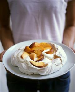 Man holding peach pavlova