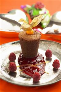 Small chocolate soufflé with raspberry sauce