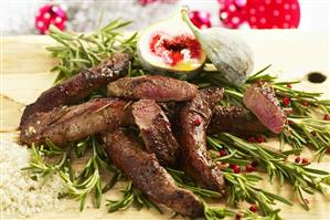 Venison fillet with fleur de sel on rosemary with fig