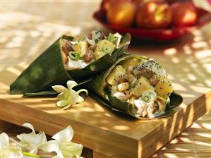 Chicken and peach salad with peanuts in banana leaf