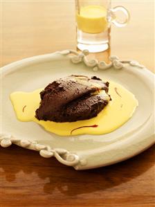 Chocolate mousse on saffron sauce