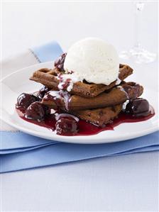 Chocolate waffles with cherry sauce and vanilla ice cream