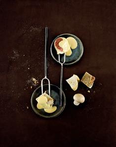 Cheese fondue with cubes of bread and fig