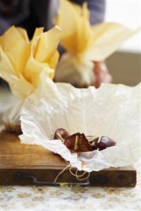 Plums in parchment paper