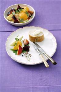 Fruit salad with slice of baguette