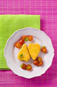 Fried cheese hearts with cherry tomatoes