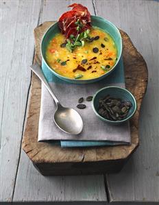 Crushed potato soup with coppa crisps and pumpkin seeds