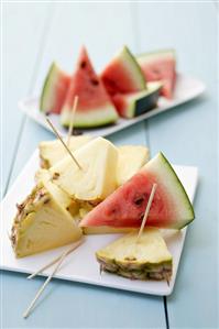 Pieces of pineapple & watermelon with wooden cocktail sticks