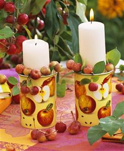 Candles in mugs filled with crab-apples