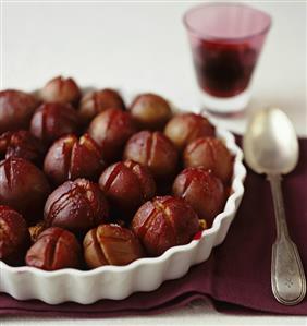 Plum tart in tart dish, silver spoon beside it