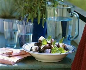 Plums stuffed with soft cheese, mineral water