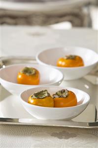 Sharon fruit in three small bowls