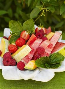 Melon slices, raspberries and strawberries on plate