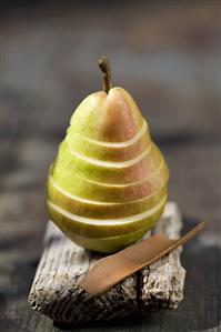 A sliced pear and cinnamon bark