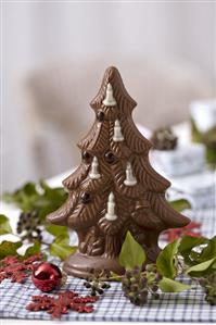 Chocolate Christmas tree among ivy berries